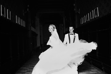 Wall Mural - Bride is happily smiling in front of the groom