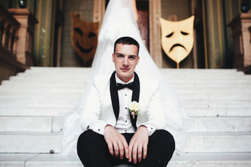 Wall Mural - Groom in the suit and decorations behind him