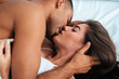 © Drobot Dean - Sensual young couple kissing and making love in bed
