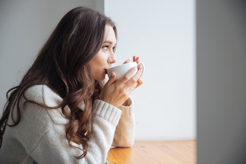 Poster - Young woman in sweater with tea