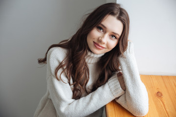 Canvas Print - Woman in sweater near the window