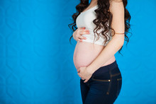 Close Up Pregnant Woman On Blue Background
