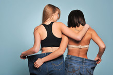 Two Fit Young Woman In Loose Jeans