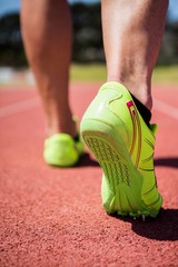 Wall Mural - Athletes feet running on the racing track