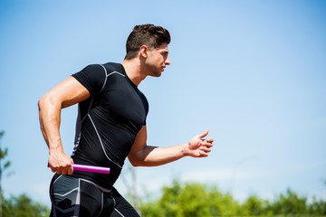 Wall Mural - Relay athlete running with baton