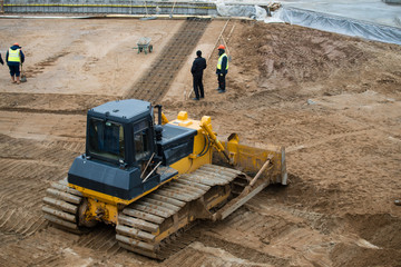 Yellow Construction bulldozer at Work in the pit, preparing the