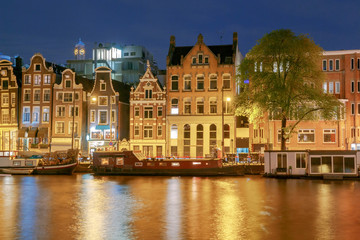 Wall Mural - Amsterdam. Night view of the houses along the canal.