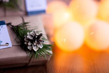 Decorated gift boxes and garland on the wooden background