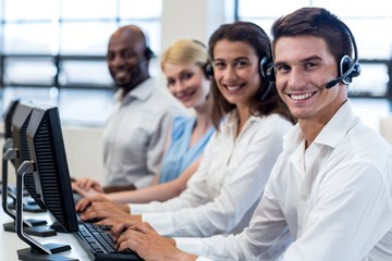 Team of colleagues sitting at their desk with headset