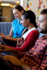 Aufkleber - Colleagues using digital tablet and laptop while sitting on sofa
