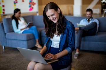 Aufkleber - Young woman using laptop