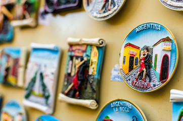 Fridge magnets with traditional tango dancers at a weekend fair in San Telmo neighborhood, Buenos Aires. Selective focus.