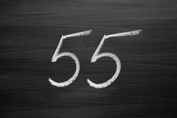 Wall Mural - number fifty five enumeration written with a chalk on the blackboard