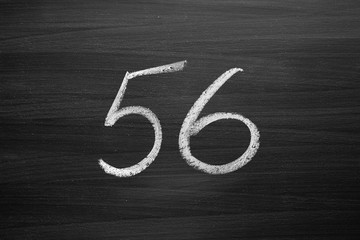 Wall Mural - number fifty six enumeration written with a chalk on the blackboard