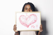 Happy young african woman holding an white board, with the 
