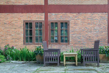 Chair and table front home brick outdoor in garden.