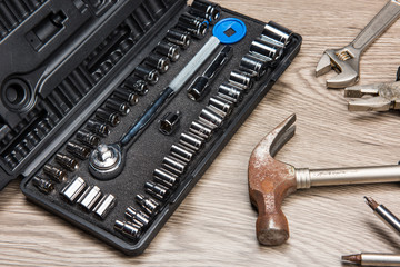 The repair tools is placed on the wooden table.