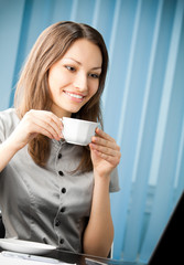 Wall Mural - businesswoman with coffee working with laptop at office