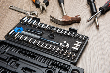 The repair tools is placed on the wooden table.