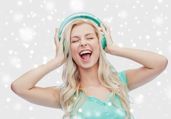 Wall Mural - happy young woman or teenage girl with headphones