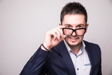 Wall Mural - Portrait  of Bearded man look over glasses