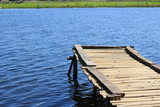 Fototapeta Pomosty - Old wood bridge in water in the summer.