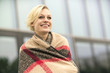 © Westend61 - Portrait of smiling blonde woman wrapped in cloth