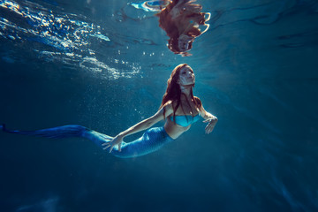 Freediver girl with mermaid tale