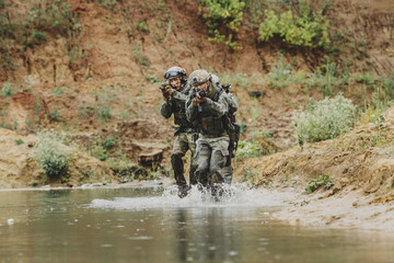 Wall Mural - Military team crossing the river under fire