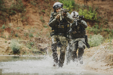 Wall Mural - Military team crossing the river under fire