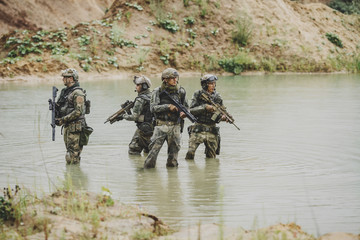 Wall Mural - Military team crossing the river under fire