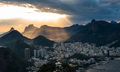 Wall Mural - Sun is shining through the clouds on the Rio de Janeiro city, View from the Sugarloaf Mountain