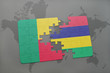 puzzle with the national flag of benin and mozambique on a world map