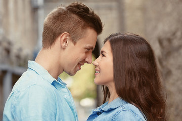 Wall Mural - Portrait of beautiful young couple outdoors on blurred background