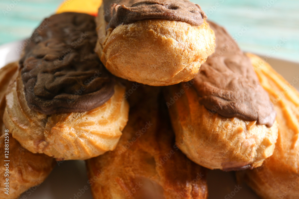 Delicious eclairs with chocolate, close up