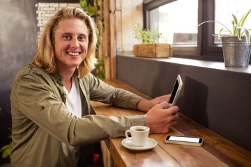 Poster - Young man using digital tablet in cafeteria