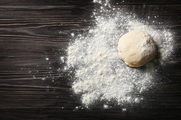 Canvas Print - Raw dough for pizza with flour on wooden table