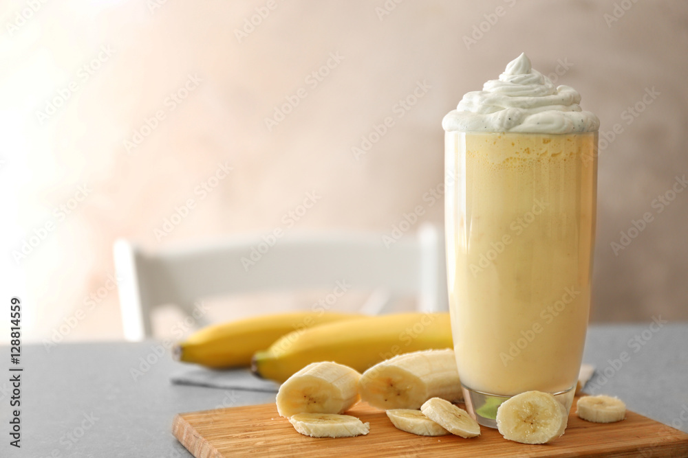 Delicious banana milkshake on table, closeup