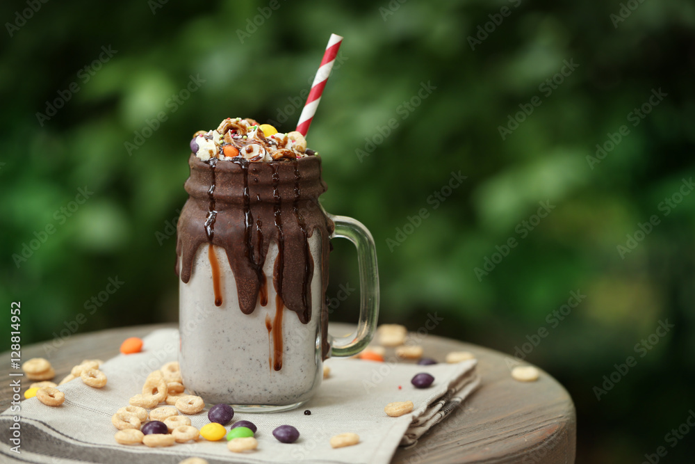 Tasty cocktail with sweets on table