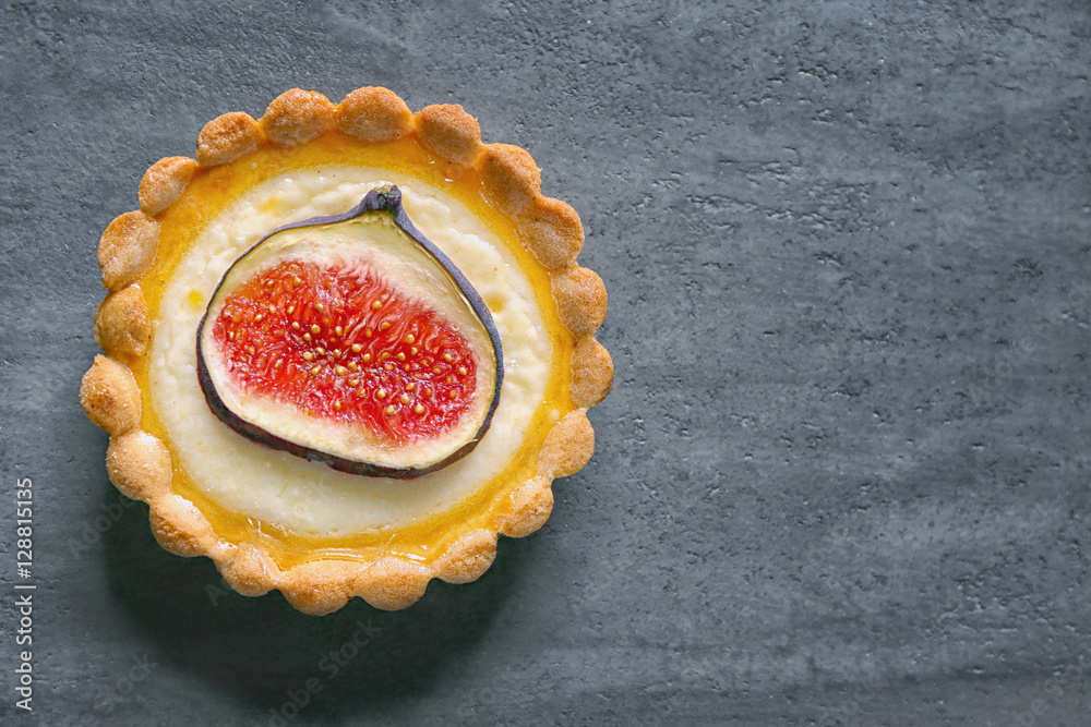 Tasty fig cake on grey background, top view