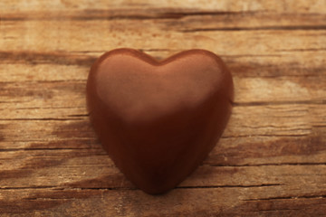 Wall Mural - Chocolate heart on wooden background