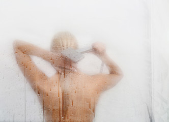 Wall Mural - Beautiful young woman  washing body in a shower