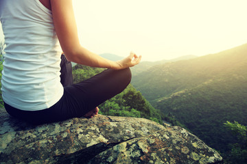 young fitness yoga woman at mountain peak