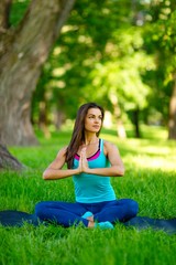 Yoga woman on green grass 