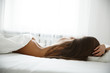 © maksimvostrikov - Attractive and appealing young woman with gorgeous naked back and shapely buttocks is lying in the bed and sleeping on the white sheets opposite the window, soft light