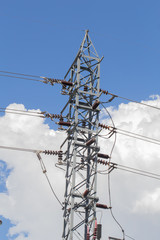 high voltage electricity post or high-power tower against sky background