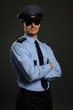 © petrdlouhy - Portrait of young policeman in uniform on gray background
