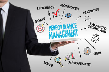 Wall Mural - Performance Management concept. Young man holding a tablet compu