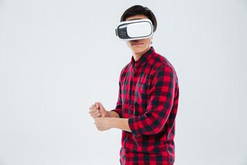 Wall Mural - Man wearing virtual reality device and holding imagine tennis racket