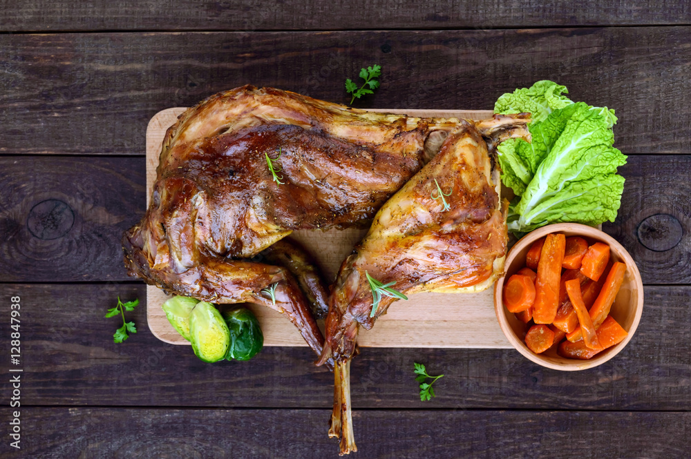 Toasting A Rabbit Roast whole rabbit on a wooden board with baked carrots and Brussels ...